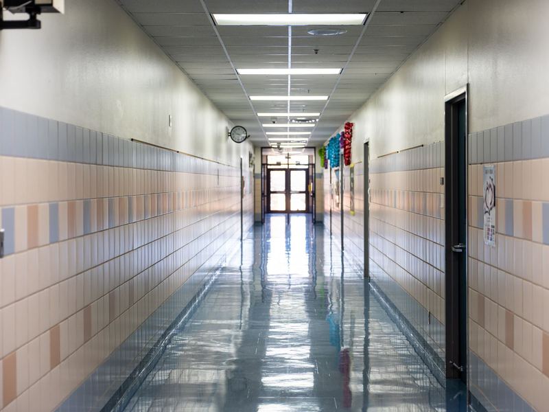 Long hallway with freshly cleaned, glossy polished floors
